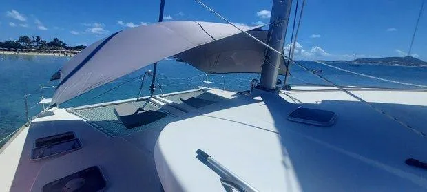 Katarina Yacht Photos Pics Lagoon 440 catamaran, 2010 model, anchored in clear blue waters under a sunny sky.