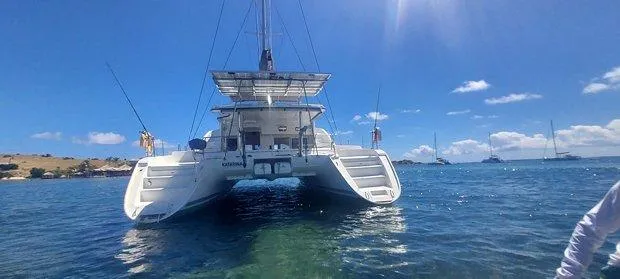 Katarina Yacht Photos Pics 2010 Lagoon 440 catamaran anchored in clear blue waters under a sunny sky.