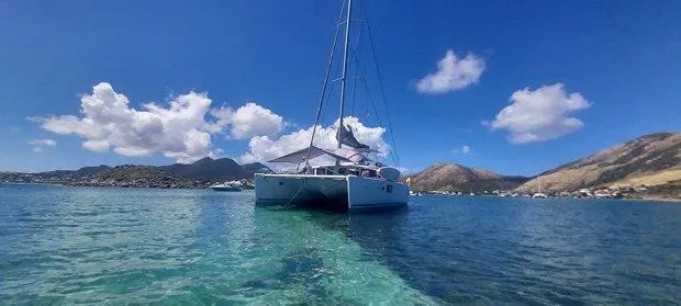 Katarina Yacht Photos Pics Lagoon 440 catamaran sailing in clear blue waters, 2010 model, under a bright sky.