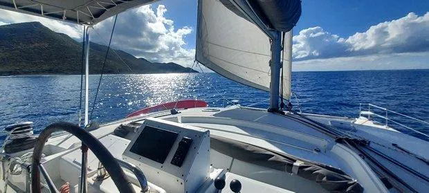 Katarina Yacht Photos Pics Lagoon 440 catamaran sailing on open sea, sunny day, scenic coastal view, 2010 model.