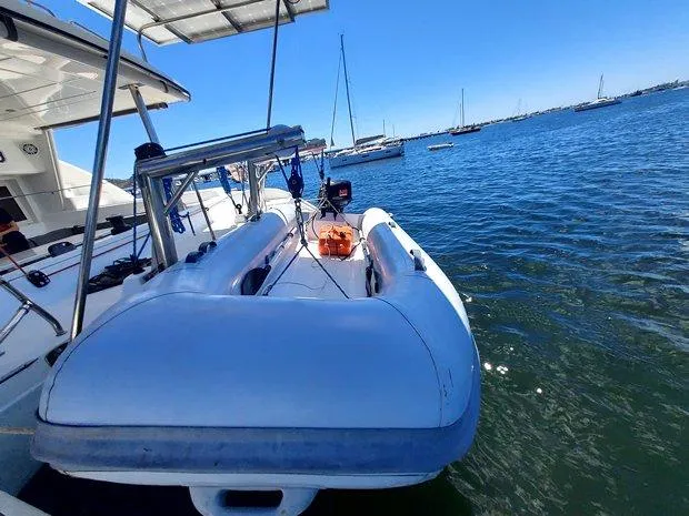 Katarina Yacht Photos Pics 2010 Lagoon 440 yacht with inflatable dinghy on calm water.