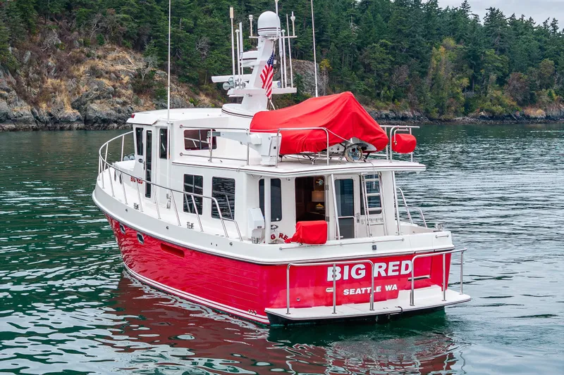 Big Red Yacht Photos Pics 2007 American Tug 41 "Big Red" on scenic waterway near forested shoreline.