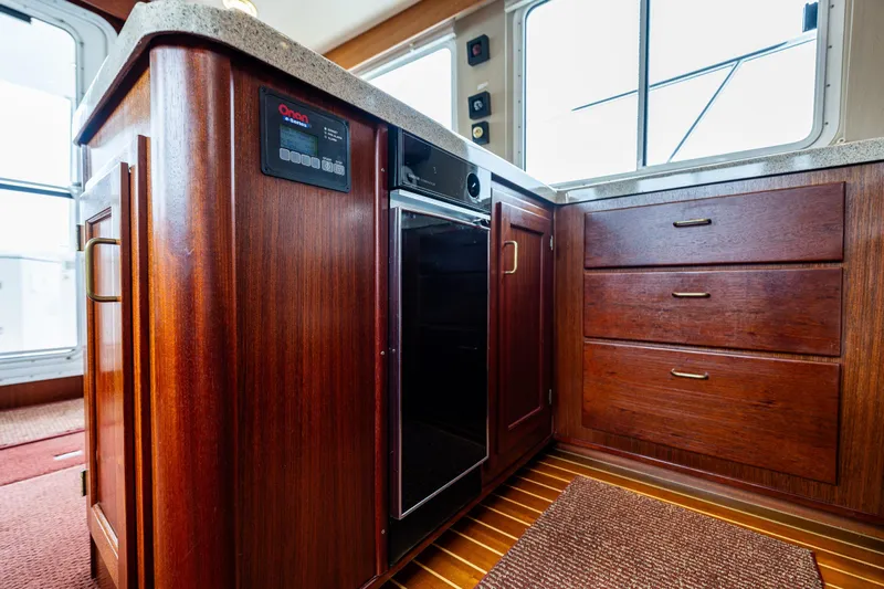 Big Red Yacht Photos Pics Luxurious 2007 American Tug 41 interior with rich wood cabinetry and modern appliances.