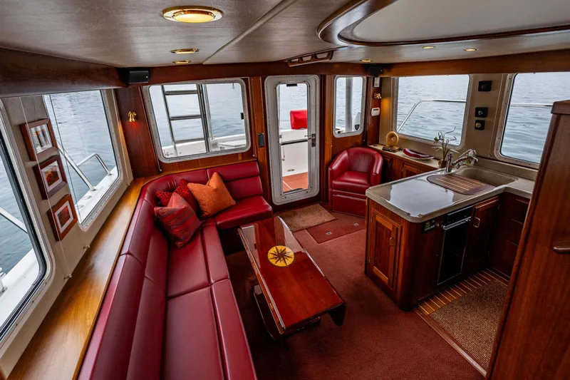 Big Red Yacht Photos Pics Luxurious interior of 2007 American Tug 41 with red leather seating and wooden finishes.