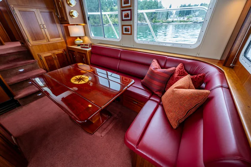 Big Red Yacht Photos Pics Luxurious interior of 2007 American Tug 41 with red leather seating and elegant wood table.
