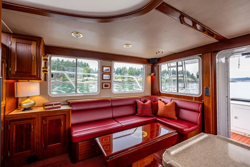 Big Red Yacht Photos Pics Luxurious interior of 2007 American Tug 41 with red seating and scenic windows.