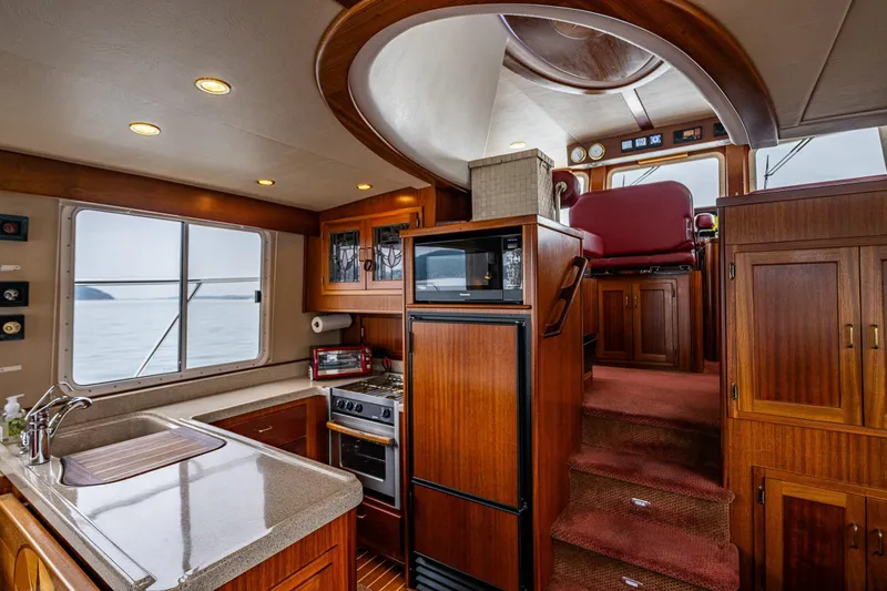 Big Red Yacht Photos Pics Interior of 2007 American Tug 41 with wood cabinetry and modern kitchen amenities.