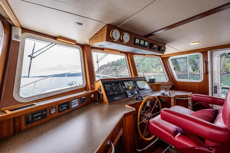 Big Red Yacht Photos Pics Interior of 2007 American Tug 41, featuring a well-equipped helm with scenic views.