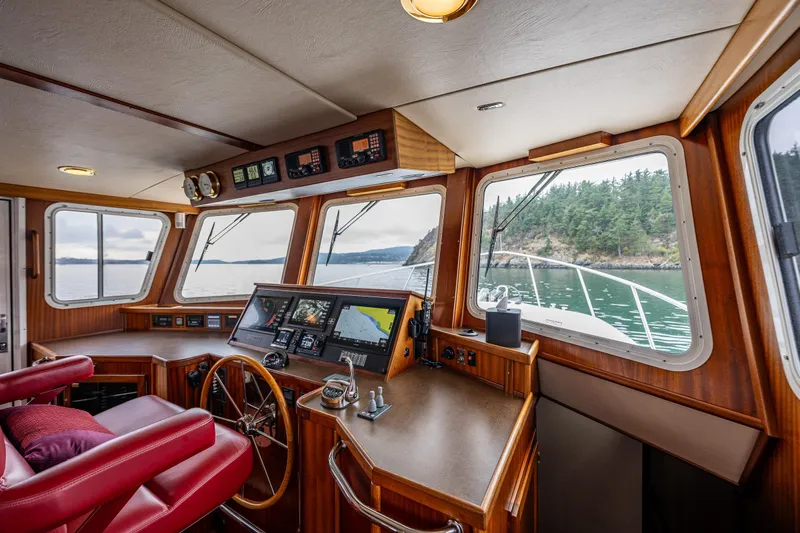 Big Red Yacht Photos Pics Pilothouse of 2007 American Tug 41 with navigation equipment and scenic water view.