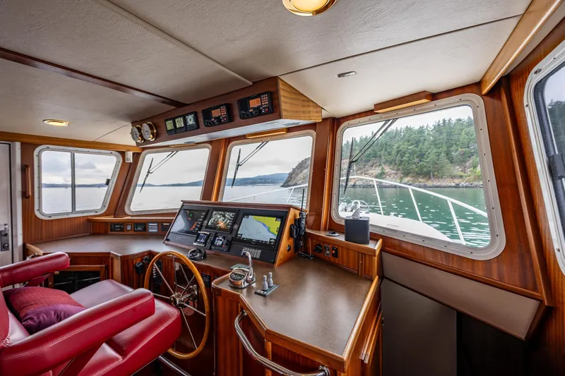 Big Red Yacht Photos Pics Pilothouse of 2007 American Tug 41 with panoramic windows and navigation equipment.