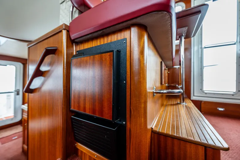 Big Red Yacht Photos Pics Interior of 2007 American Tug 41, featuring polished wood and red seating.