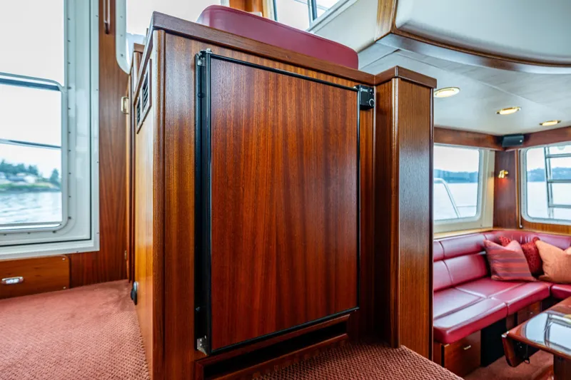 Big Red Yacht Photos Pics Interior of 2007 American Tug 41 with wood paneling and red seating.