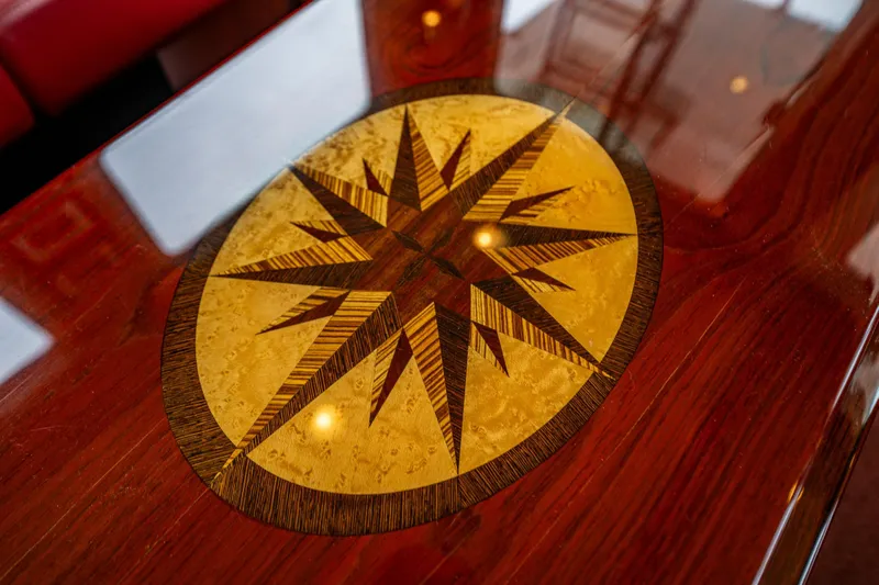 Big Red Yacht Photos Pics Wooden table with compass rose inlay on a 2007 American Tug 41 yacht.