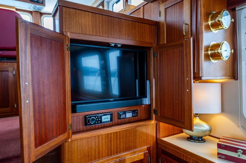 Big Red Yacht Photos Pics Interior of 2007 American Tug 41 with wooden cabinetry and built-in TV.