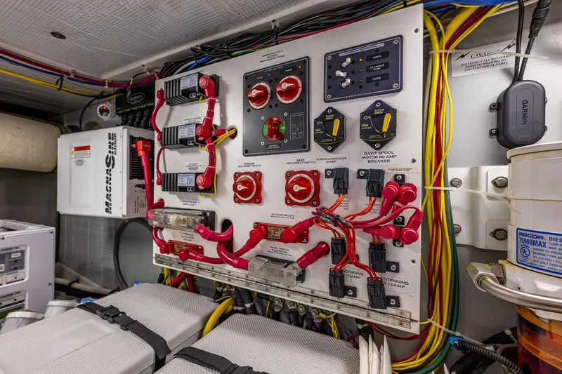 Big Red Yacht Photos Pics Electrical panel in a 2007 American Tug 41 boat, featuring wiring and control switches.