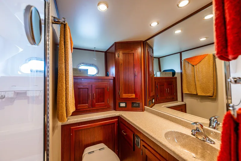 Big Red Yacht Photos Pics Luxurious bathroom in 2007 American Tug 41 yacht with wood cabinetry and modern fixtures.