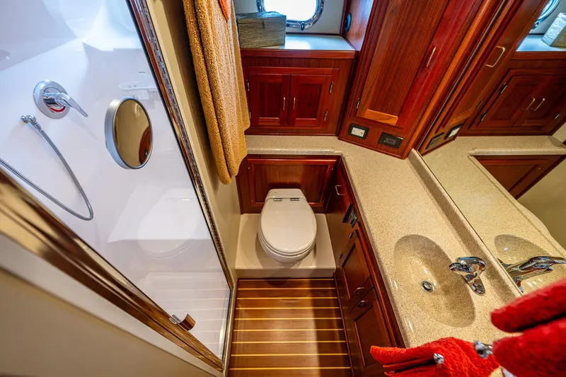 Big Red Yacht Photos Pics Luxurious bathroom in 2007 American Tug 41 yacht with wood cabinetry and modern fixtures.