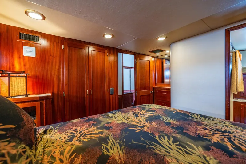 Big Red Yacht Photos Pics Luxurious cabin interior of 2007 American Tug 41 with wood paneling and cozy bedding.