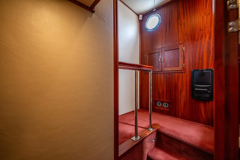 Big Red Yacht Photos Pics Interior of 2007 American Tug 41 with wooden paneling and carpeted stairs.