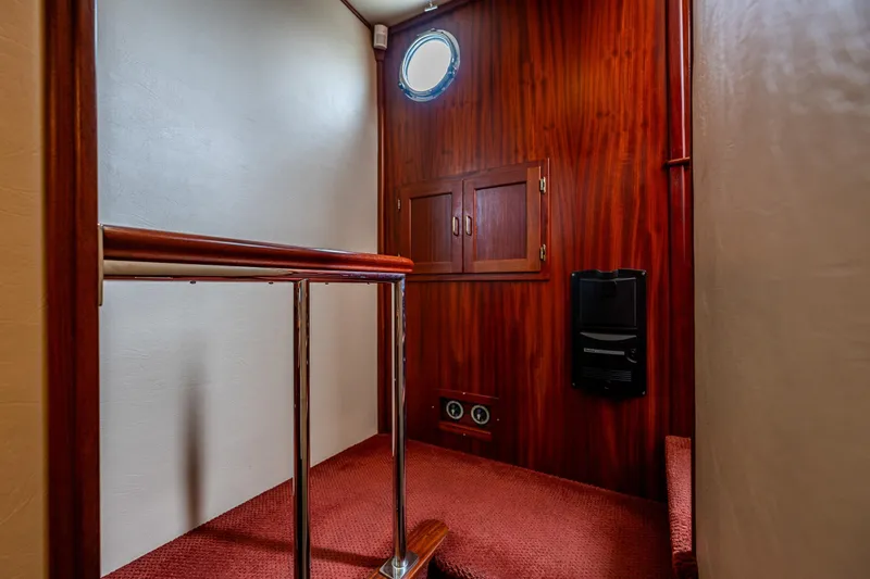 Big Red Yacht Photos Pics Interior of 2007 American Tug 41 with wood paneling and porthole window.
