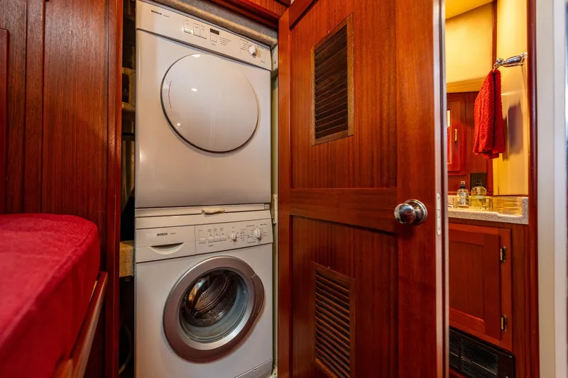 Big Red Yacht Photos Pics Laundry area with stacked washer and dryer in 2007 American Tug 41 boat.