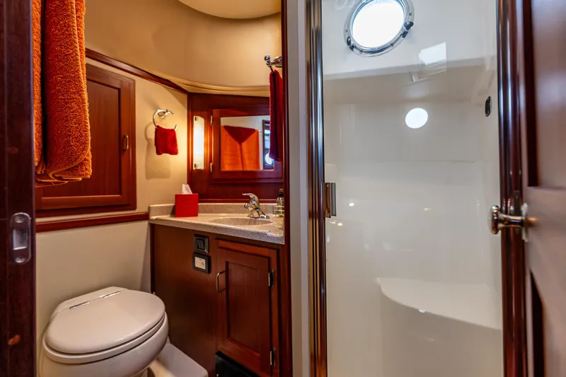 Big Red Yacht Photos Pics Luxurious bathroom in 2007 American Tug 41 yacht with wood cabinetry and modern fixtures.