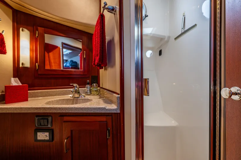 Big Red Yacht Photos Pics Luxurious bathroom in 2007 American Tug 41 with wood cabinetry and modern fixtures.