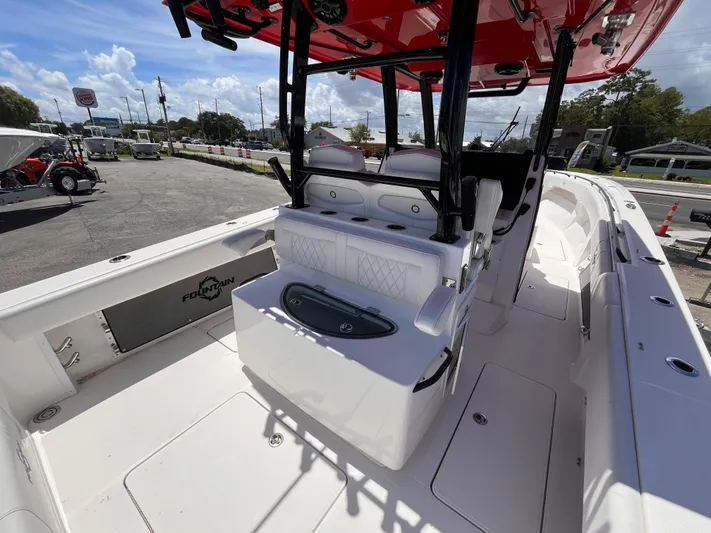  Yacht Photos Pics 2023 Fountain 38 Tournament Edition boat interior with seating and storage, parked outdoors.