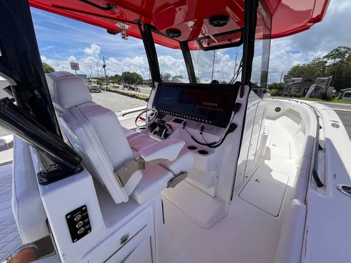  Yacht Photos Pics 2023 Fountain 38 Tournament Edition boat interior with red canopy and advanced navigation system.