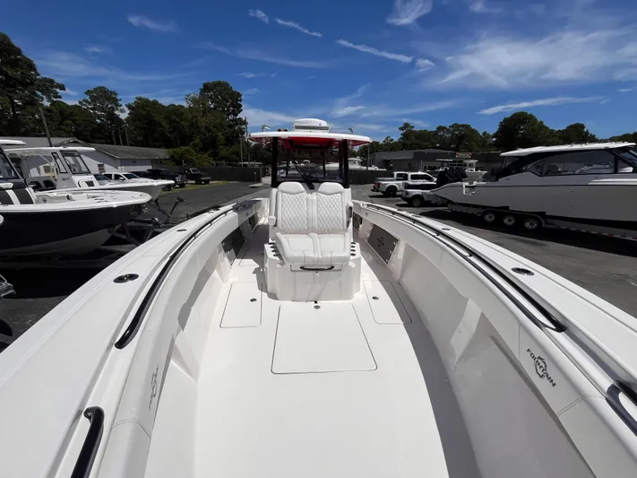  Yacht Photos Pics 2023 Fountain 38 Tournament Edition boat, sleek design, spacious deck, parked outdoors under blue sky.