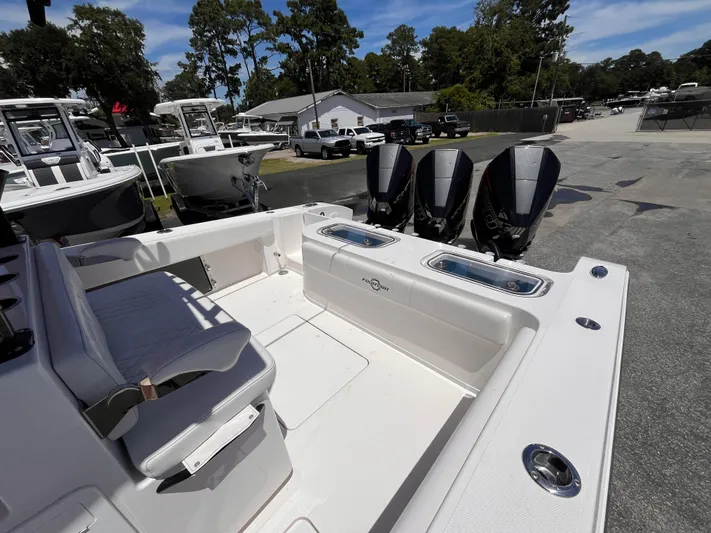  Yacht Photos Pics 2023 Fountain 38 Tournament Edition boat with triple outboard engines, docked outdoors.