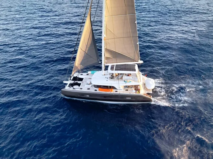 Big Picture Yacht Photos Pics 2024 Lagoon SIXTY 5 sailing yacht cruising on open blue sea.