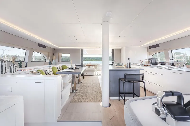 Big Picture Yacht Photos Pics Luxurious interior of 2024 Lagoon SIXTY 5 yacht with modern kitchen and seating area.