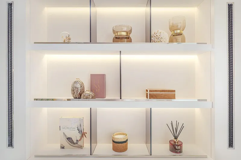 Big Picture Yacht Photos Pics Luxurious shelf decor on Lagoon SIXTY 5 yacht, featuring elegant books and ornaments, 2024 model.