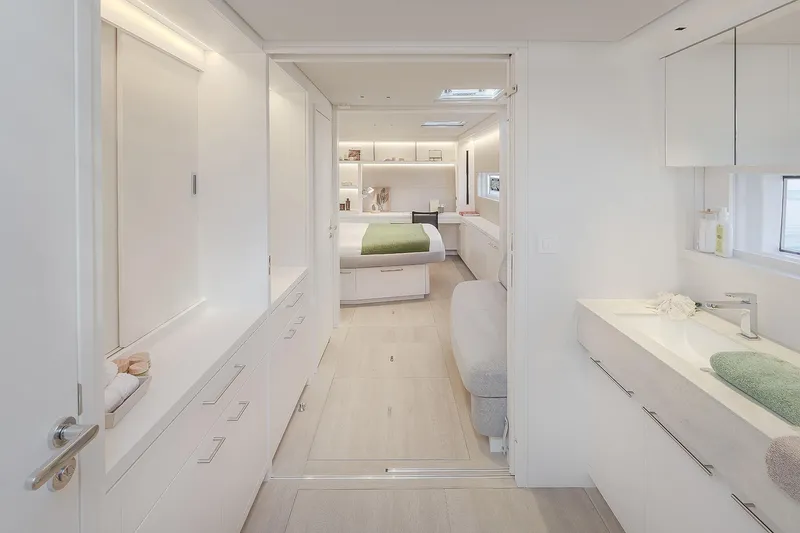 Big Picture Yacht Photos Pics Luxurious interior of 2024 Lagoon SIXTY 5 yacht, featuring modern bedroom and bathroom design.