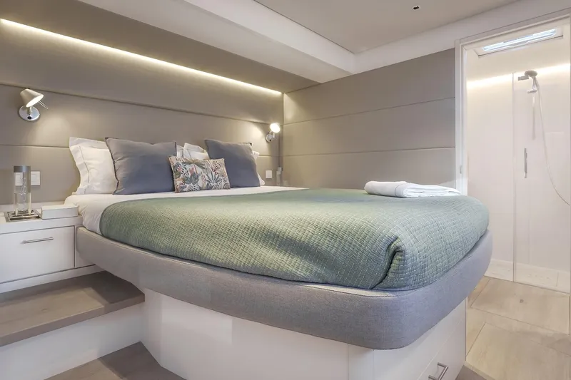 Big Picture Yacht Photos Pics Luxurious bedroom interior of 2024 Lagoon SIXTY 5 yacht with modern design and cozy bedding.