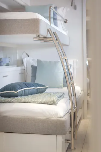 Big Picture Yacht Photos Pics 2024 Lagoon SIXTY 5 yacht interior with modern bunk beds and elegant decor.