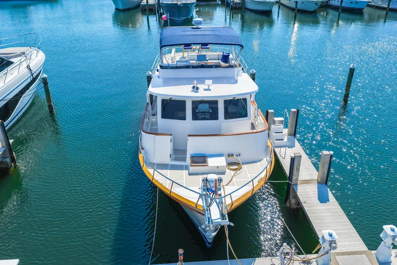 Sugar Yacht Photos Pics 2008 DeFever 52 Euro yacht docked in a marina, surrounded by calm blue water.