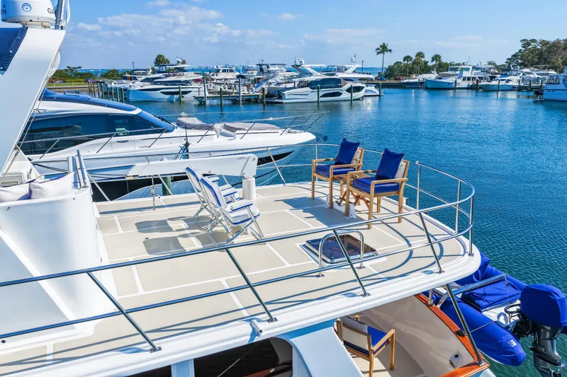 Sugar Yacht Photos Pics 2008 DeFever 52 Euro yacht with spacious deck, docked in a marina under clear skies.