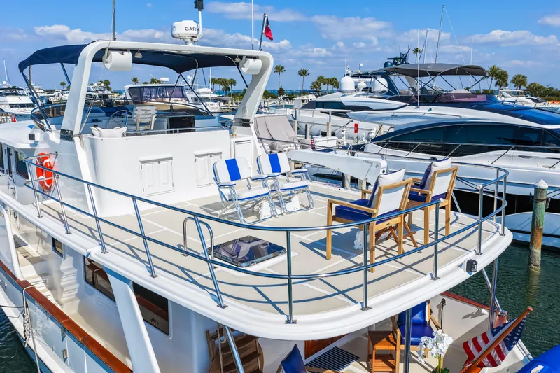 Sugar Yacht Photos Pics 2008 DeFever 52 Euro yacht with spacious deck, docked at marina under clear skies.