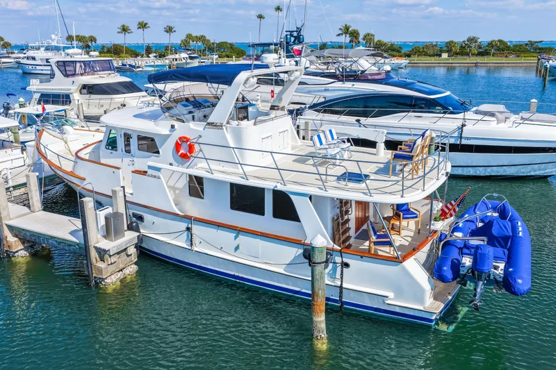 Sugar Yacht Photos Pics 2008 DeFever 52 Euro yacht docked in a marina with blue inflatable boat.