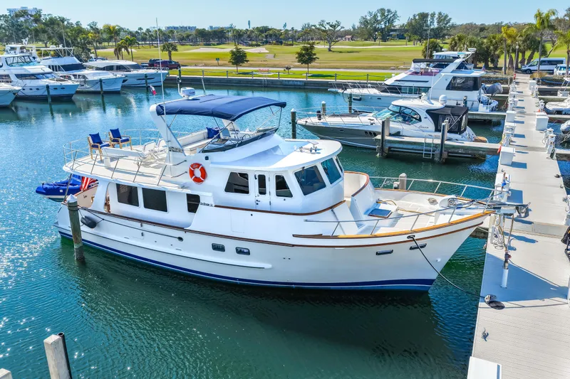 Sugar Yacht Photos Pics 2008 DeFever 52 Euro yacht docked in a marina with clear blue water.