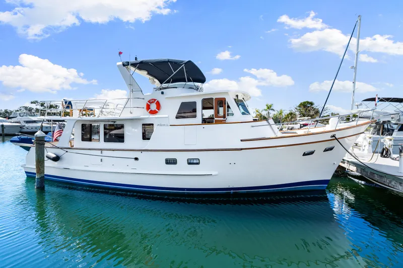 Sugar Yacht Photos Pics 2008 DeFever 52 Euro yacht docked in a marina under a clear blue sky.