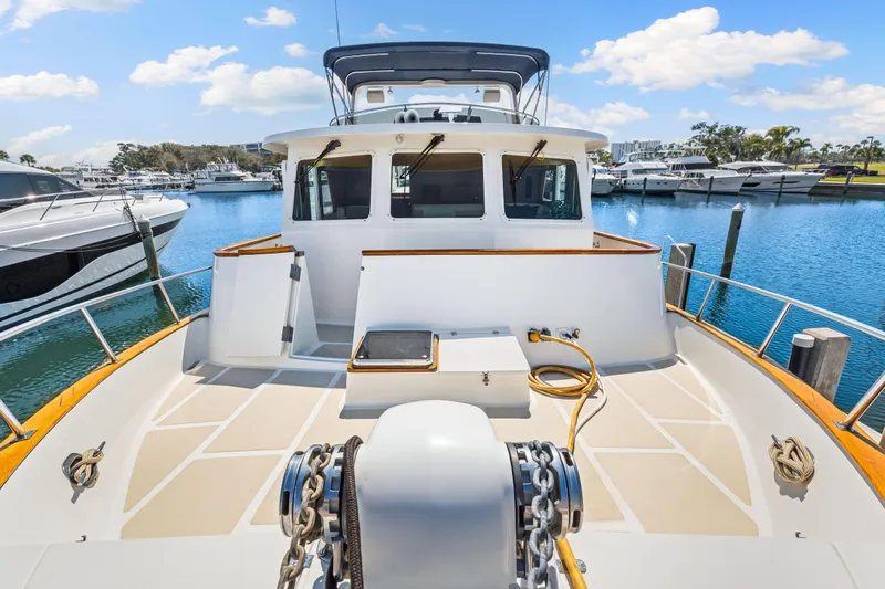 Sugar Yacht Photos Pics 2008 DeFever 52 Euro yacht docked at marina under blue sky.