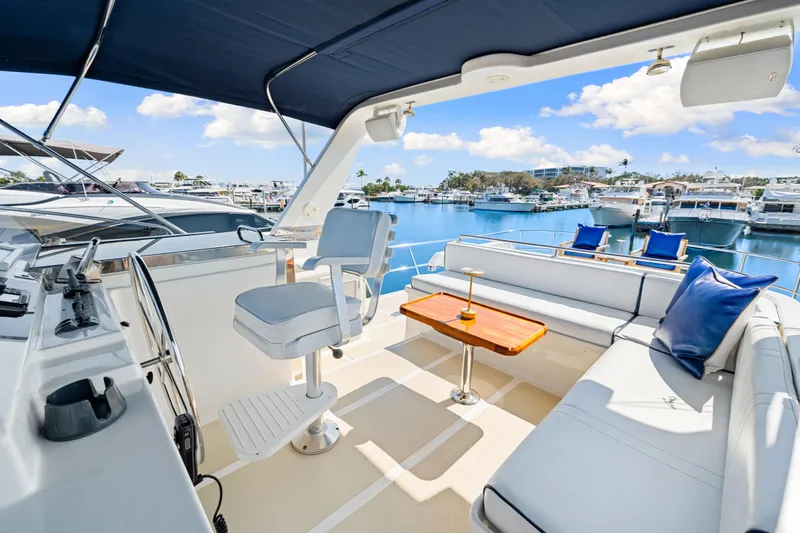 Sugar Yacht Photos Pics Luxurious 2008 DeFever 52 Euro yacht interior with seating and helm, docked at marina.