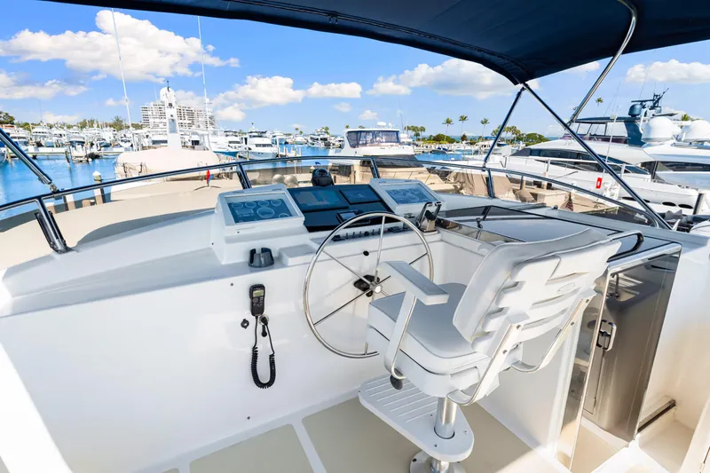 Sugar Yacht Photos Pics 2008 DeFever 52 Euro yacht helm with marina view, featuring modern navigation equipment.