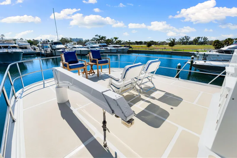 Sugar Yacht Photos Pics 2008 DeFever 52 Euro yacht deck with chairs, overlooking marina and blue sky.