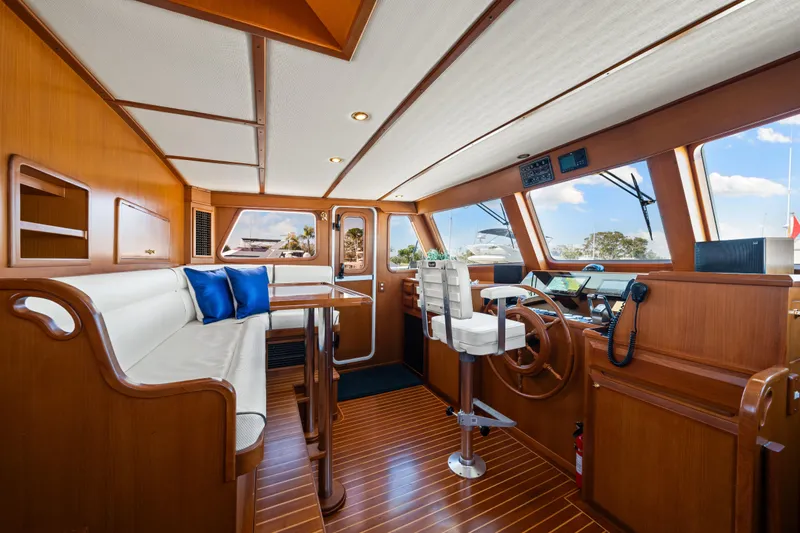 Sugar Yacht Photos Pics Luxurious interior of 2008 DeFever 52 Euro yacht with wooden finishes and modern helm.