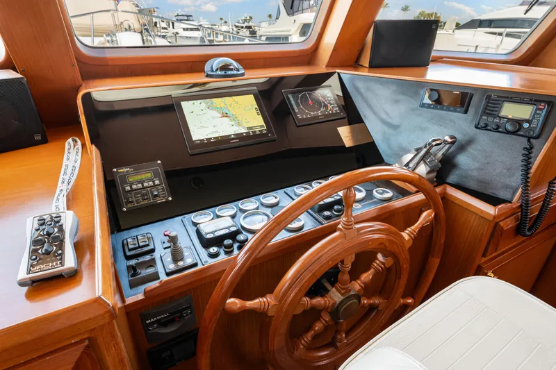 Sugar Yacht Photos Pics Pilothouse of 2008 DeFever 52 Euro yacht with navigation equipment and wooden steering wheel.