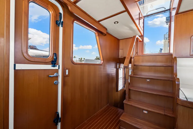 Sugar Yacht Photos Pics Interior of 2008 DeFever 52 Euro yacht with wooden stairs and door.
